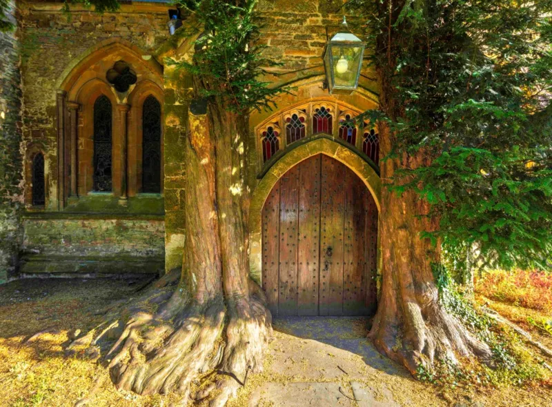 St Edward's Parish Church north door flanked by yew trees
